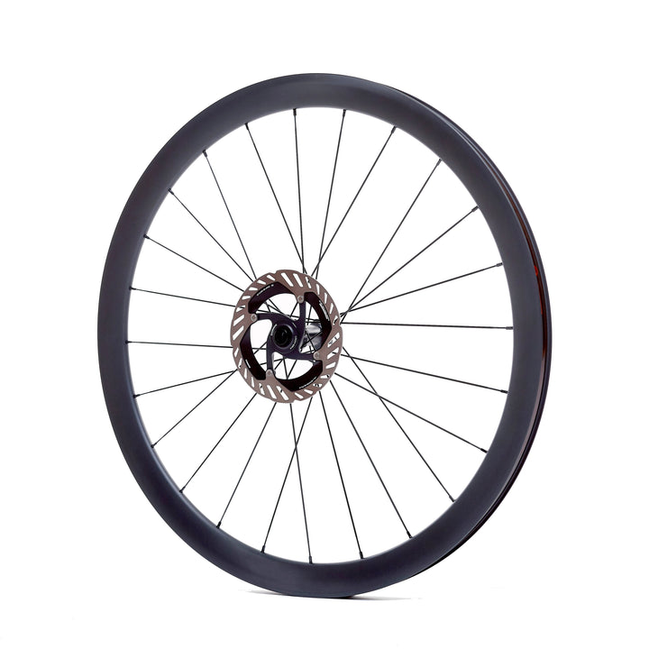 Rueda de carbono 40mm para gravel vista lateral, diseño moderno y agresivo con perfil de 40mm, bujes Ratchet System y tecnología Tubeless Ready para un rendimiento superior y control en terrenos irregulares.