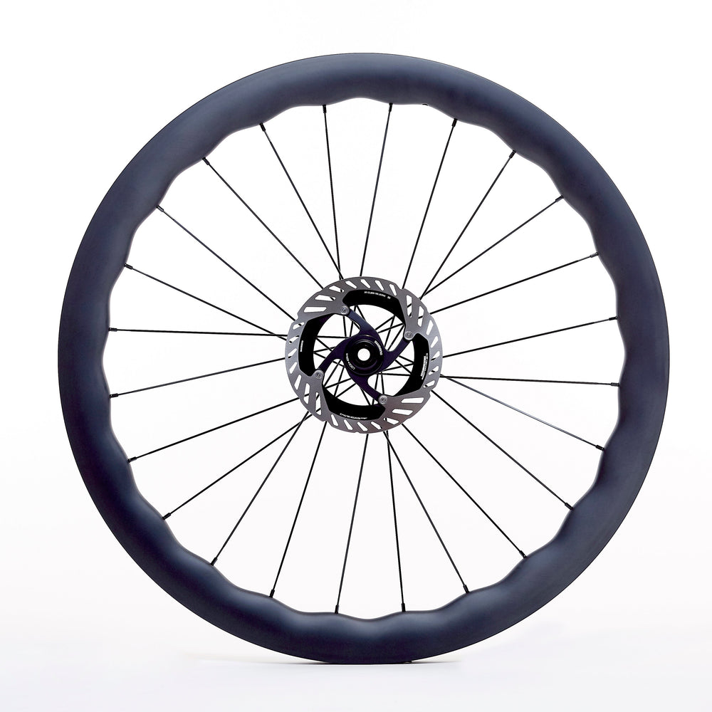 Rueda de carbono Wave para gravel, vista frontal, perfil ondulado tubeless ready de 25 mm internos